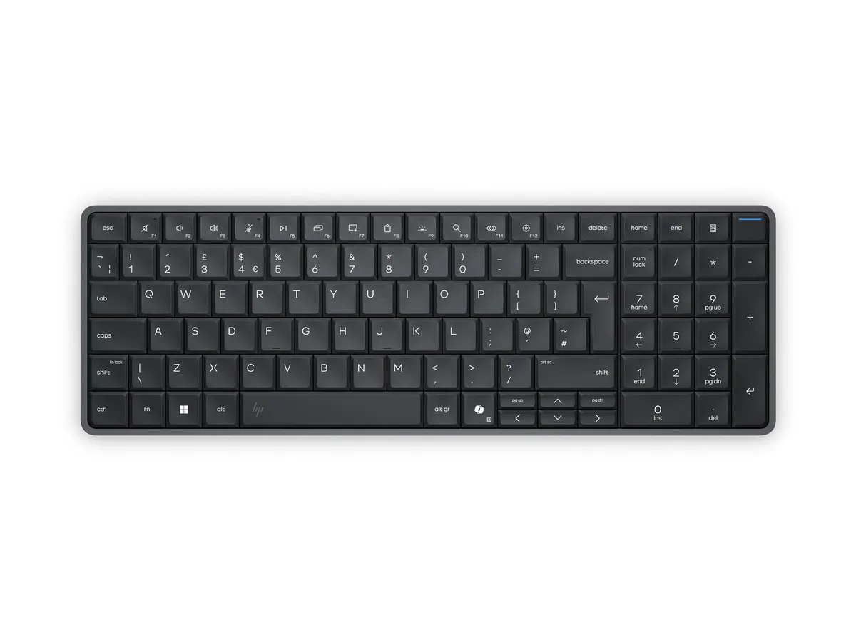 Black keyboard-form desktop PC with integrated trackpad and built-in speakers