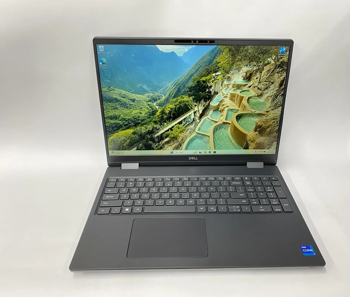 Silver Dell Precision 7670 laptop, 15.6 inch non-touch screen, visible scratches and scuffs on lid and base, charger included
