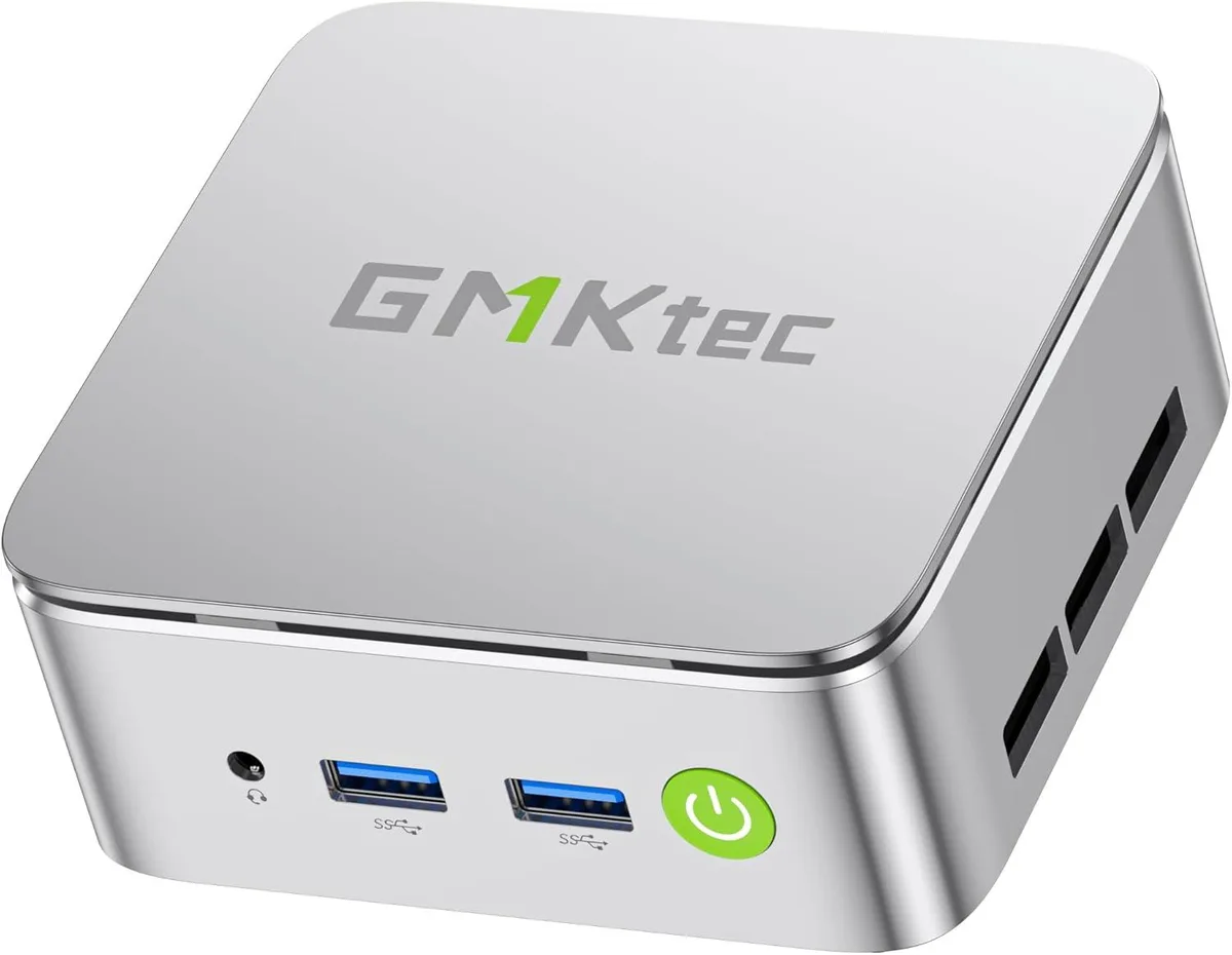 White compact mini PC with VESA mount bracket and power adapter