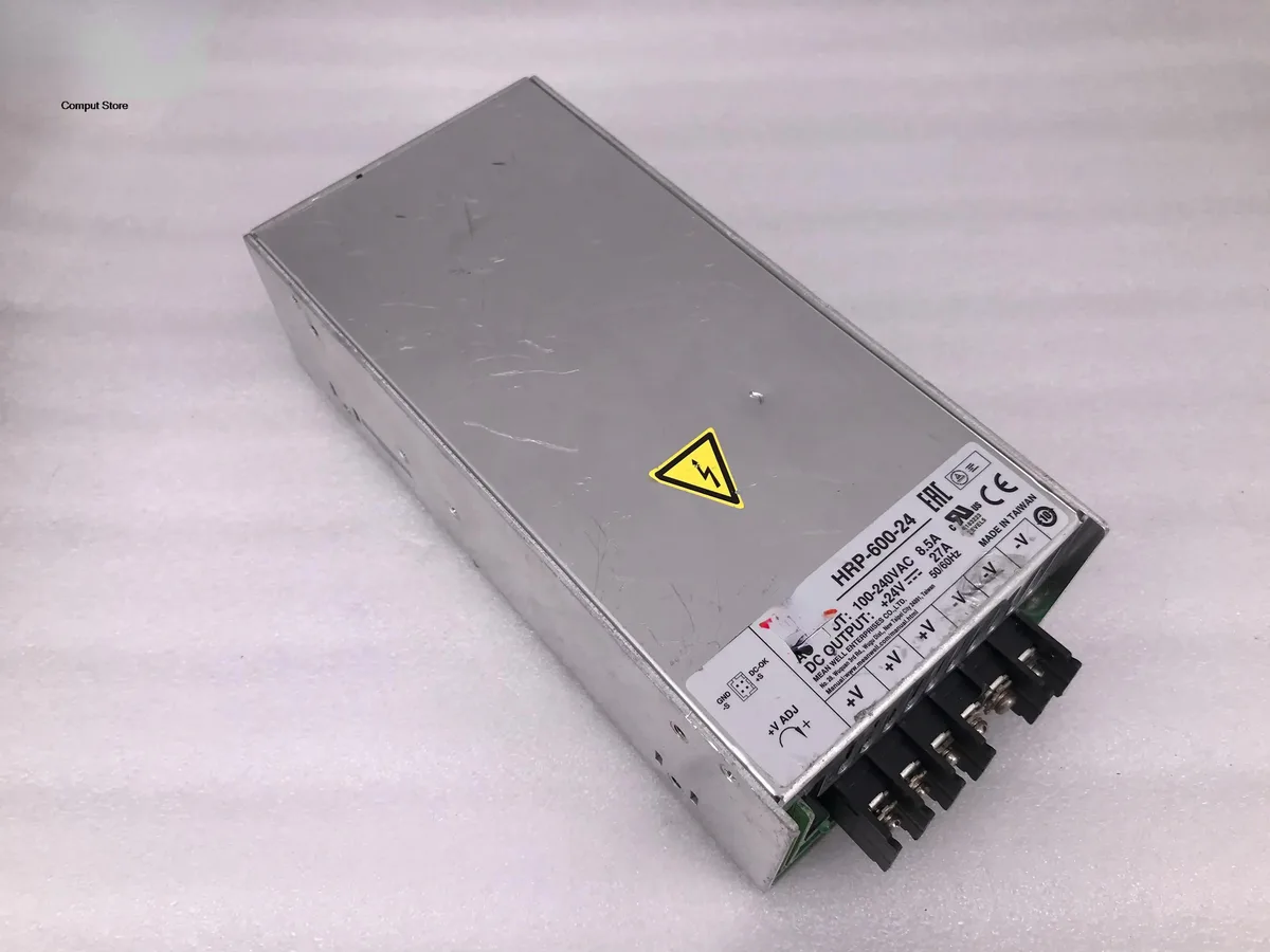 Rectangular metal industrial power supply unit with ventilation slots and terminal connections