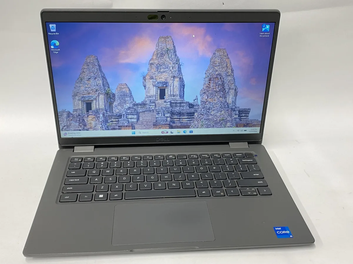 Silver Dell Latitude 3440 laptop with visible scratches on lid, 14 inch non-touch screen, charger included