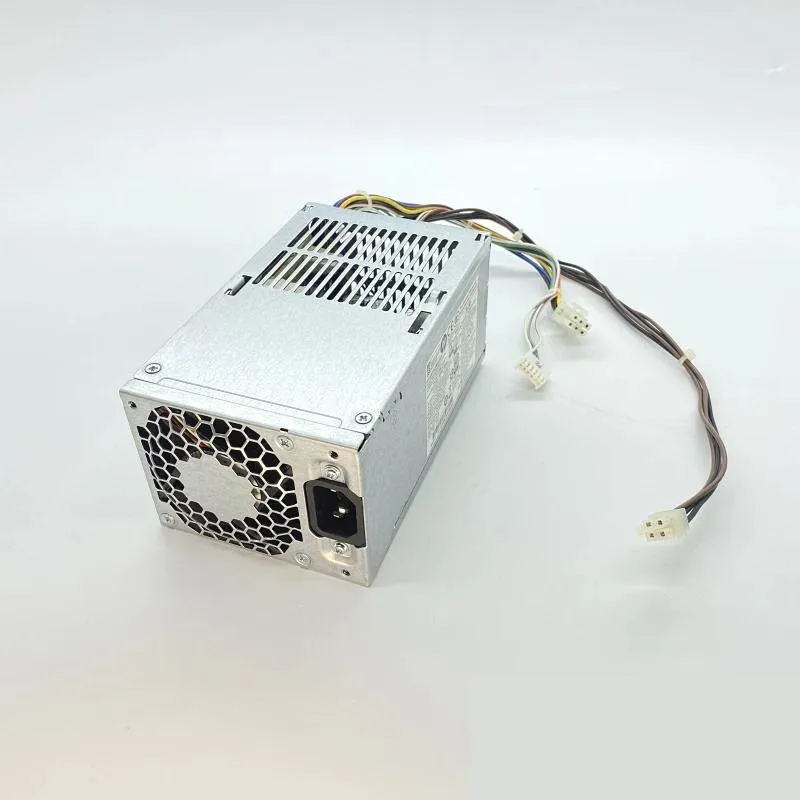 Rectangular metal ATX power supply unit with ventilation grille and cable bundle