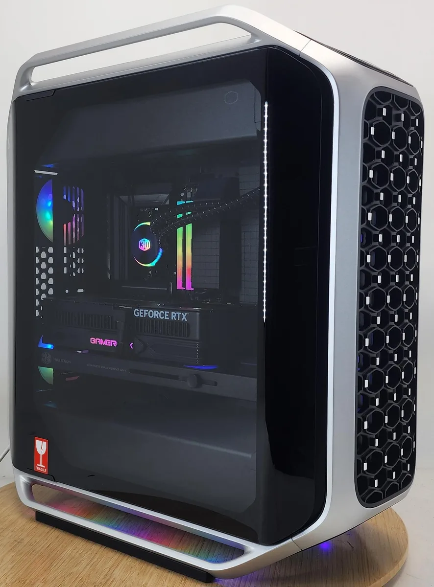 Silver Cooler Master Cosmos Alpha ATX tower with RGB liquid cooler and RTX 5090 graphics card visible through glass side panel
