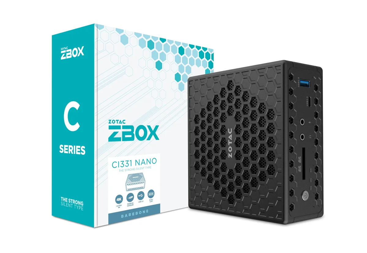 Small black fanless mini PC with honeycomb vents and VESA mount