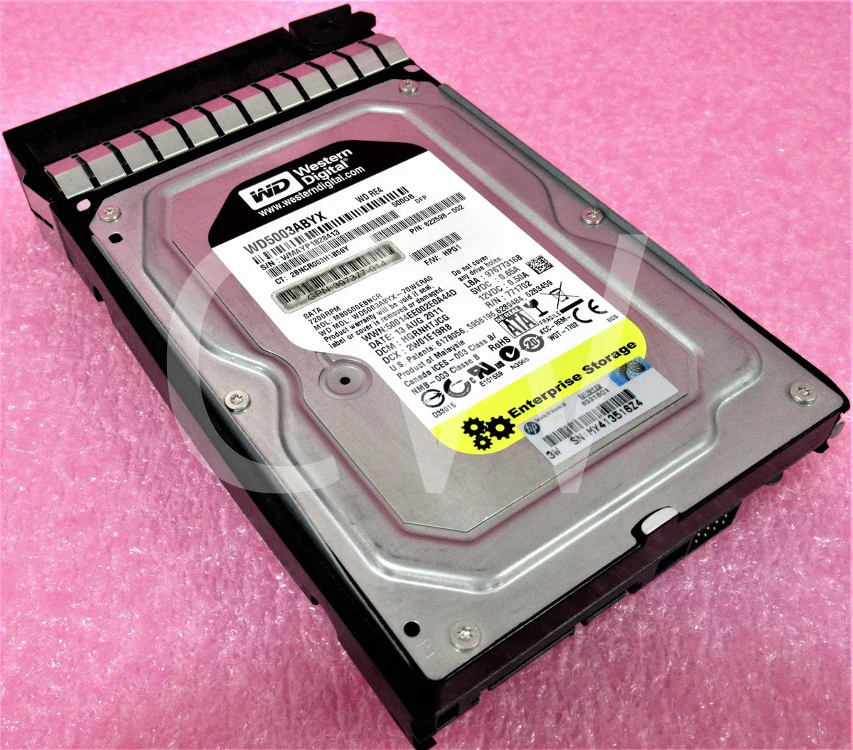 Silver 3.5-inch SATA hard drive mounted in a black plastic caddy with green release lever