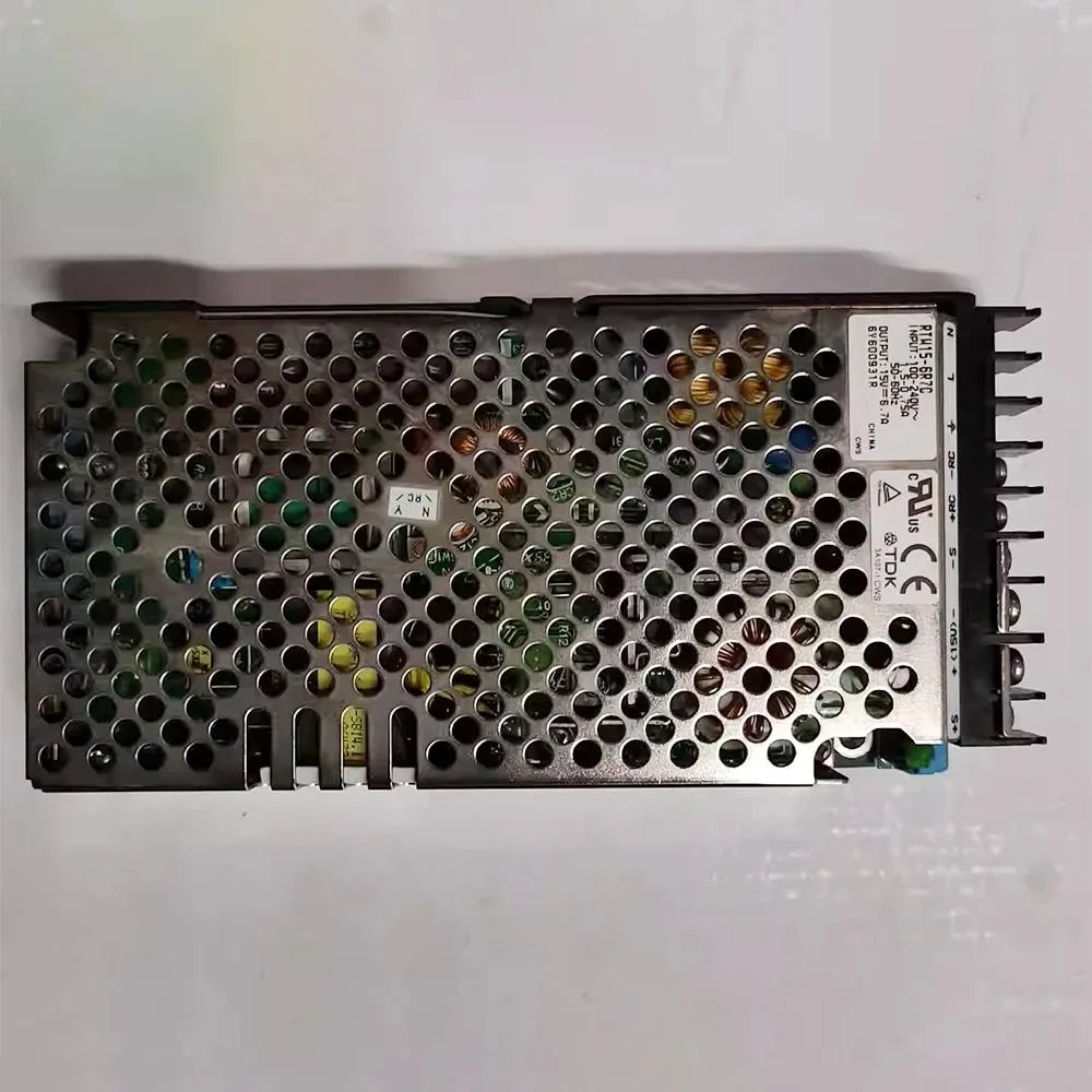 Rectangular black ATX power supply unit with label showing 15V 6.7A