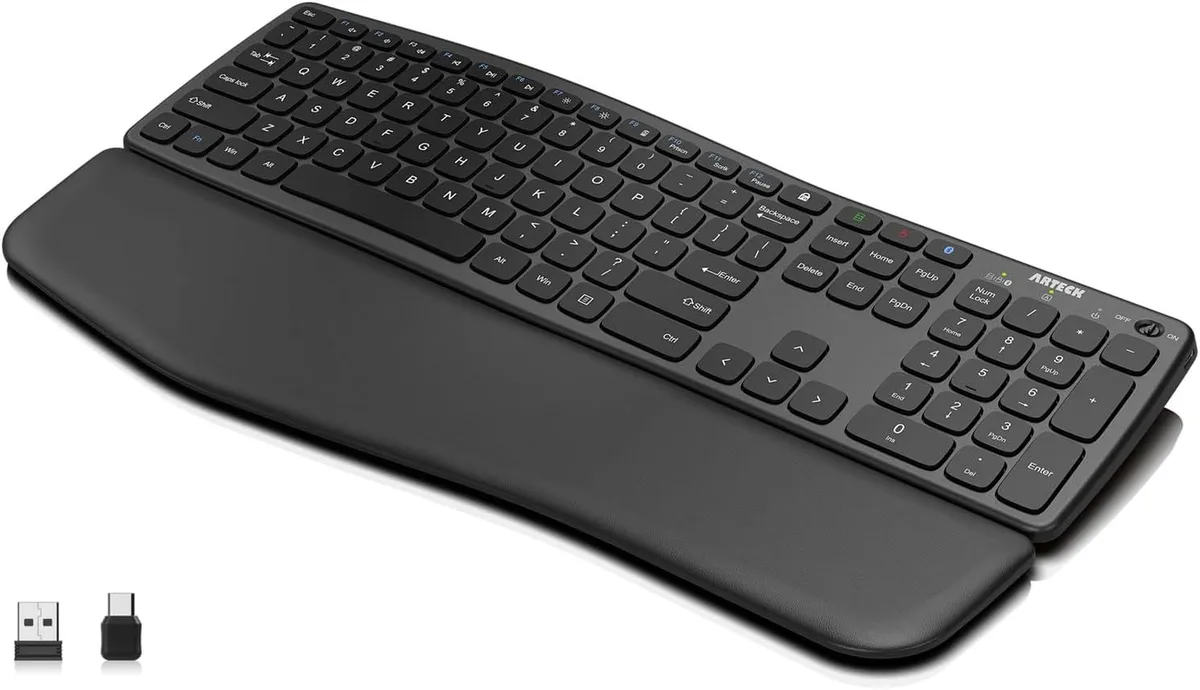 Full-size wireless keyboard with detachable cushioned palm rest, wave-shaped profile, matte black finish
