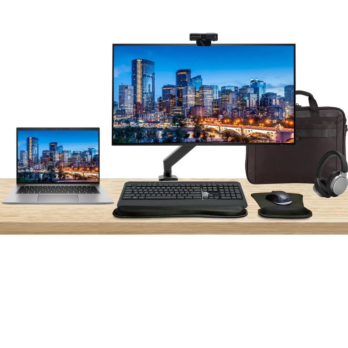 Silver 14 inch touchscreen laptop beside 32 inch 4K monitor with wireless keyboard mouse webcam headphones and briefcase