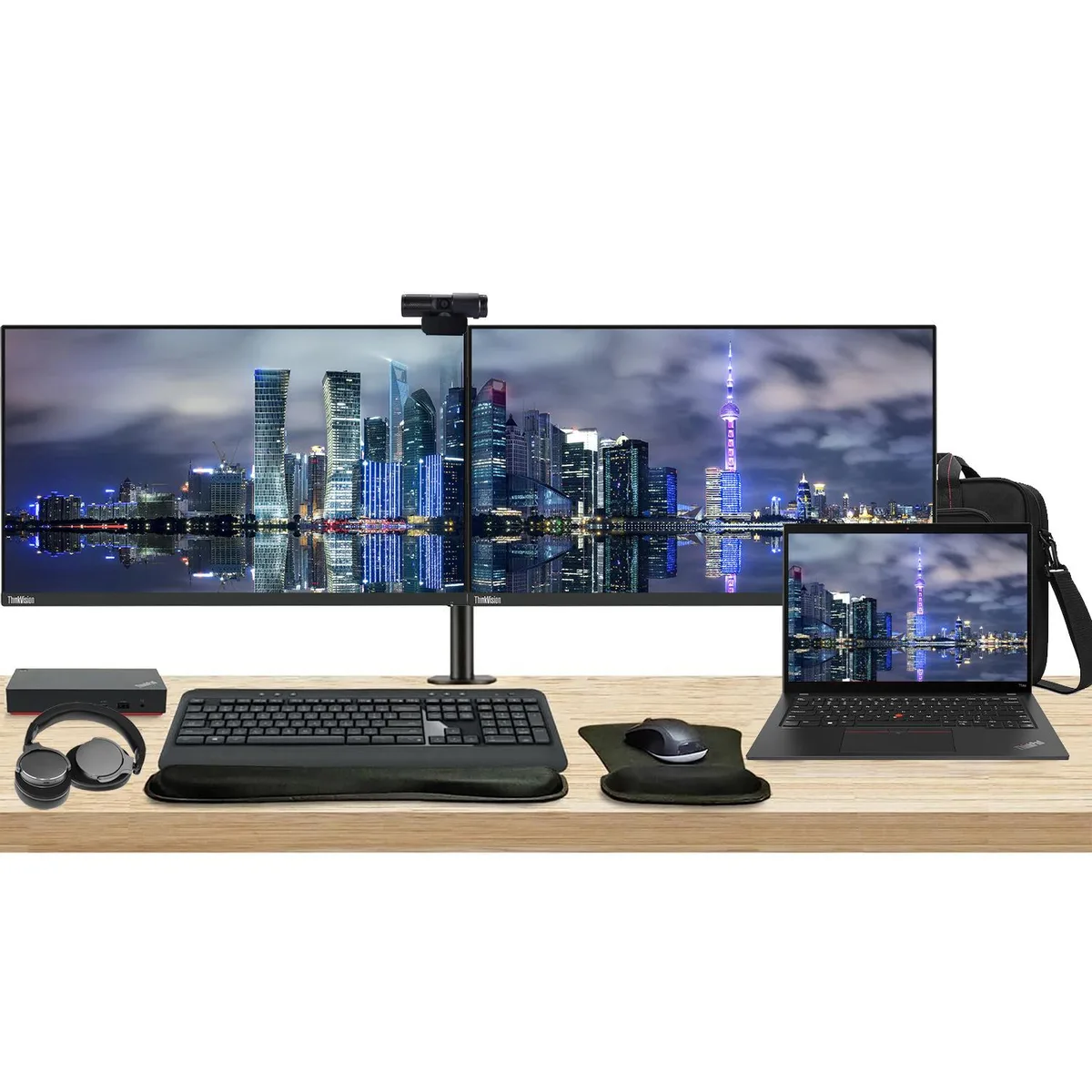 Open ThinkPad T14 laptop beside two 24 inch monitors on a dual stand with keyboard mouse webcam headphones and bag
