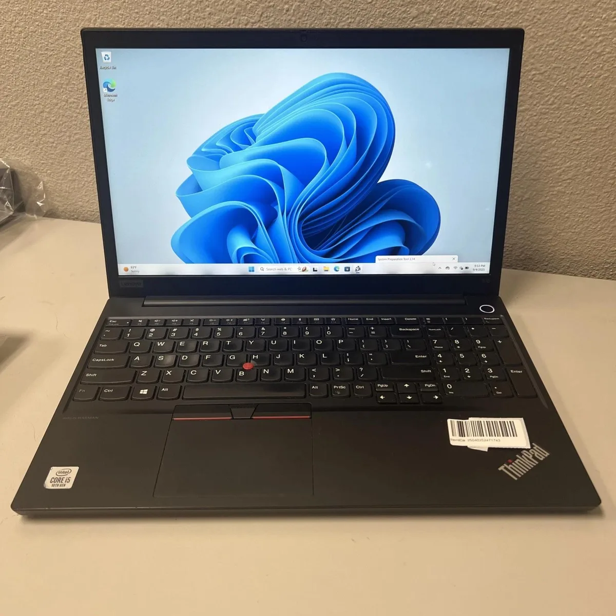 Black Lenovo ThinkPad E15 laptop with 15.6 inch screen, matte finish, visible usage wear
