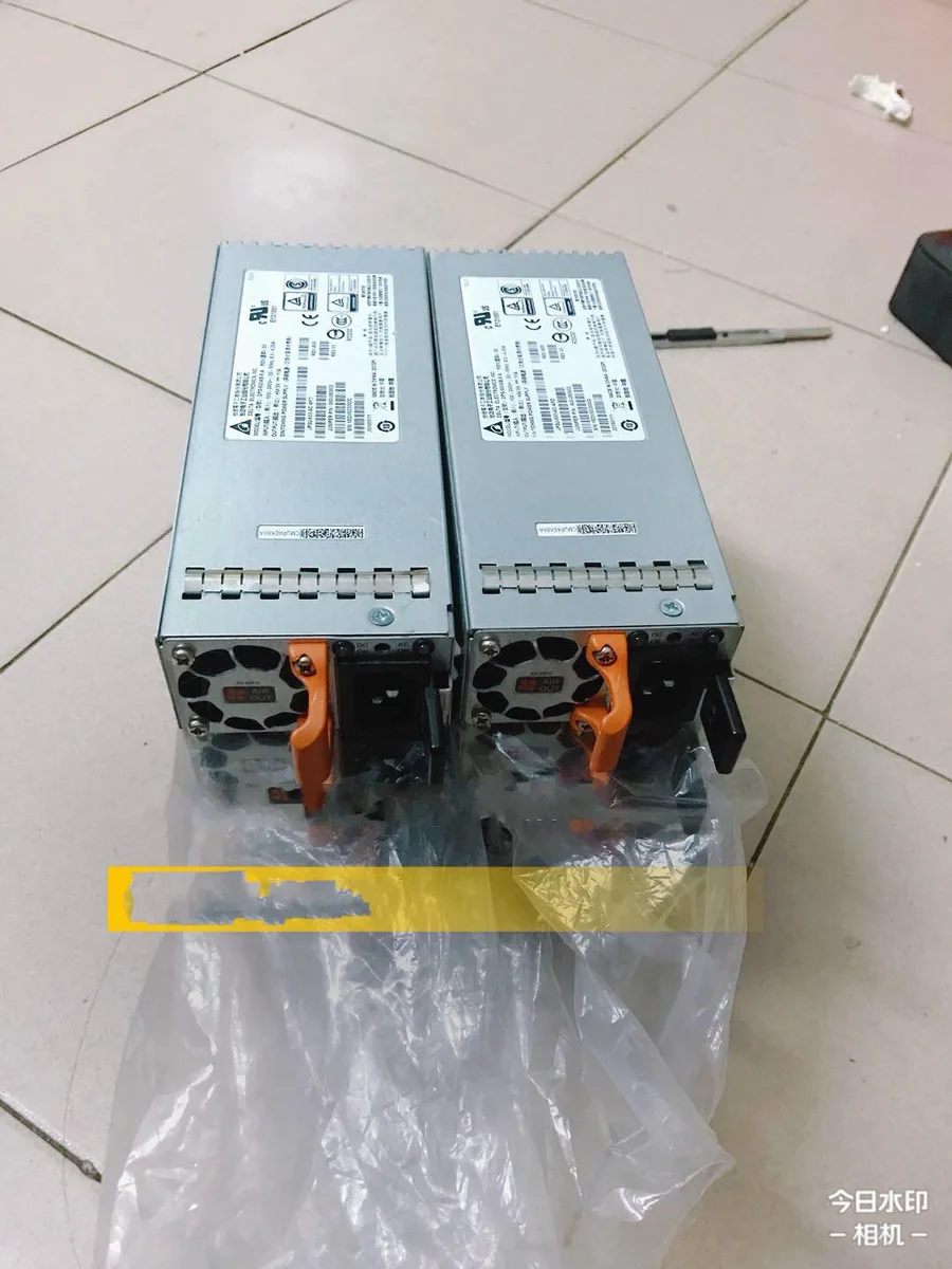 Rectangular silver ATX power supply unit with rear fan grille and power socket