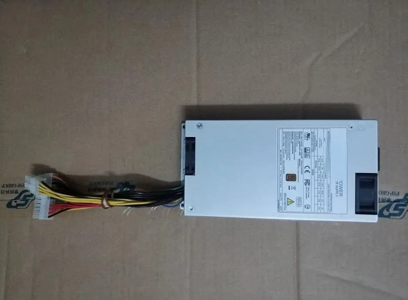 New ATX power supply unit in metal case with fan grille and cable bundle