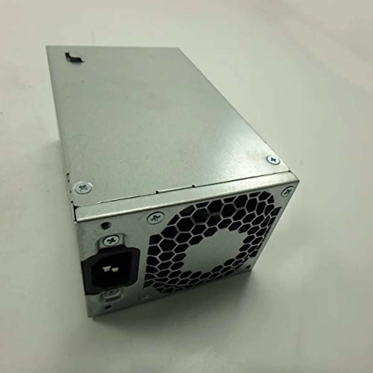 Rectangular black metal power supply unit with label and fan grille
