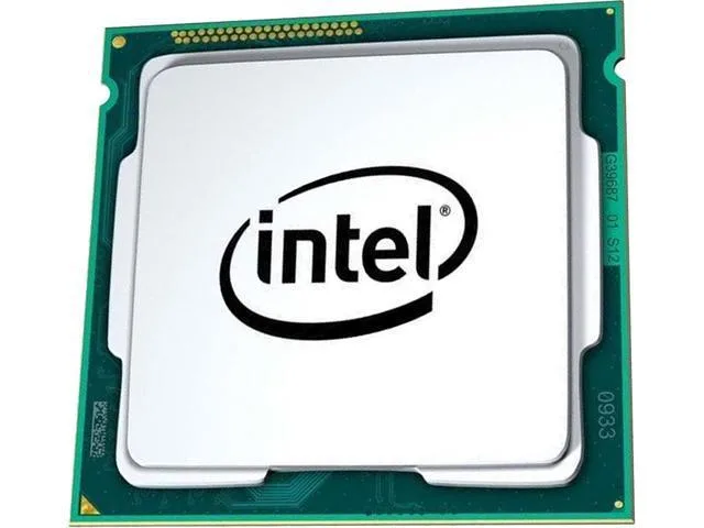 A small square gold processor with silver contacts and a green substrate visible around the edges