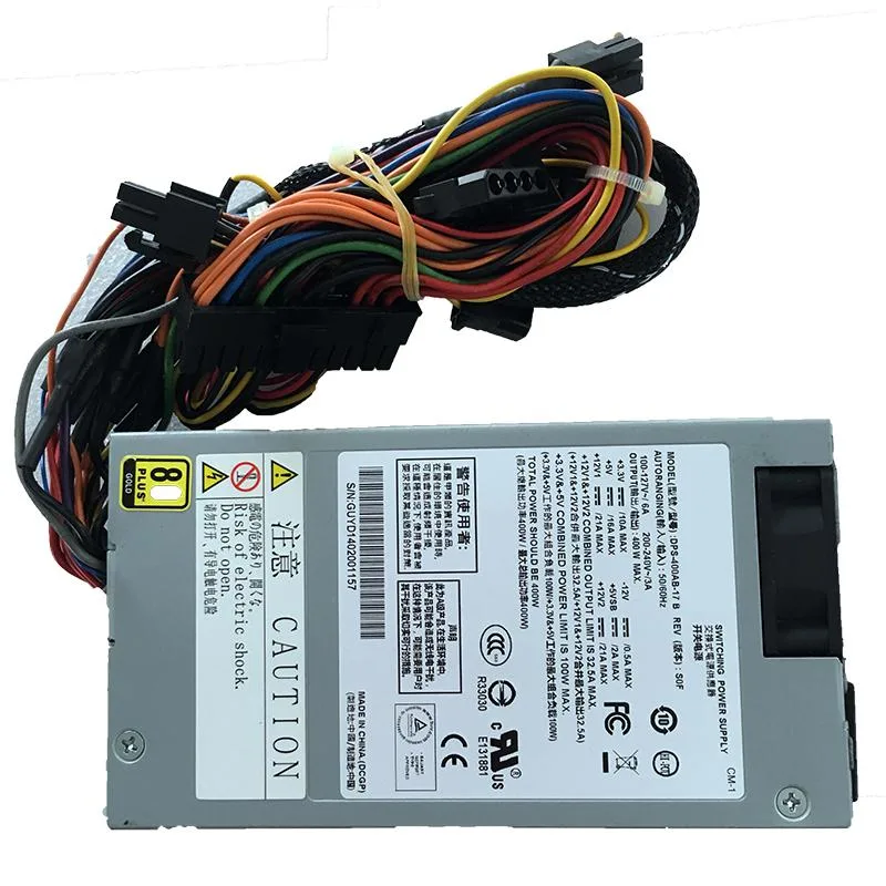 Compact silver 1U power supply with rear fan grille and modular cable sockets