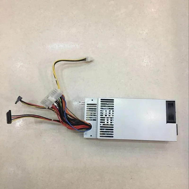 Rectangular silver ATX power supply unit with ventilation grille and label showing model numbers