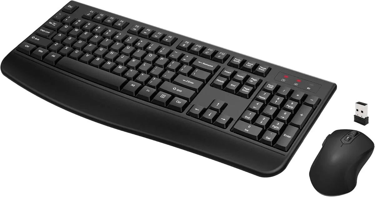 Black full-size wireless keyboard with palm rest and matching optical mouse