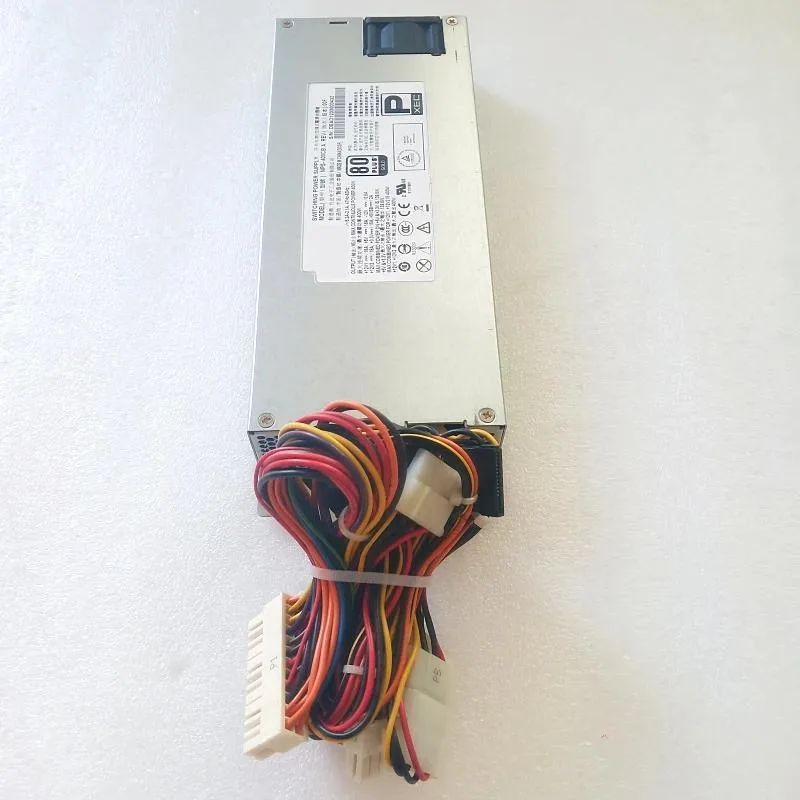 Silver 1U ATX power supply unit with rear fan grille and cable bundle