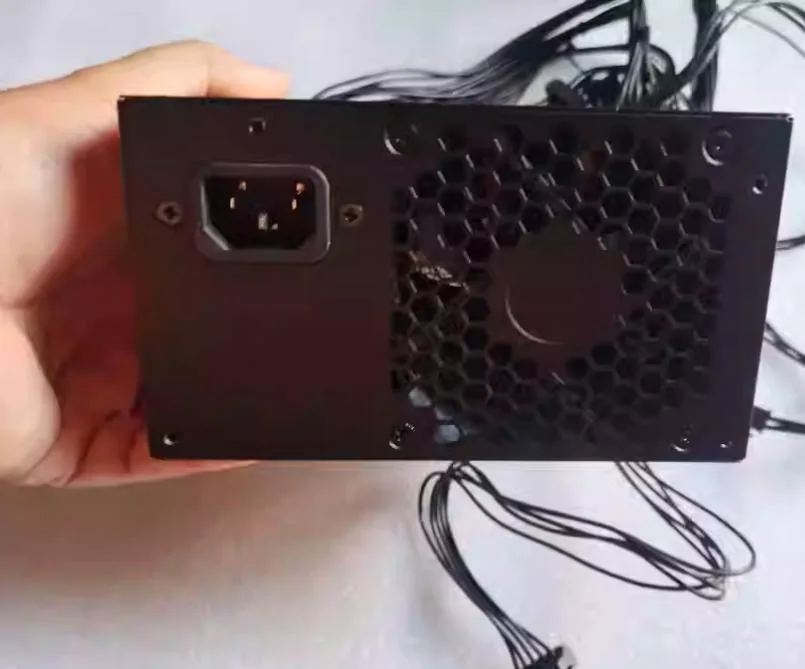 Rectangular black ATX power supply unit with rear fan grille and side label