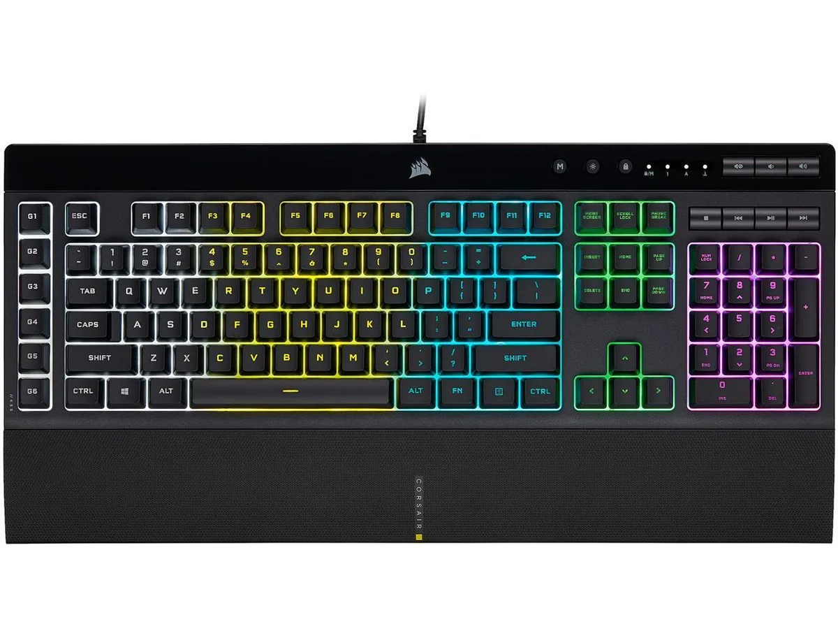 Black full-size gaming keyboard with detachable palm rest, six macro keys on left side, dedicated media controls top right