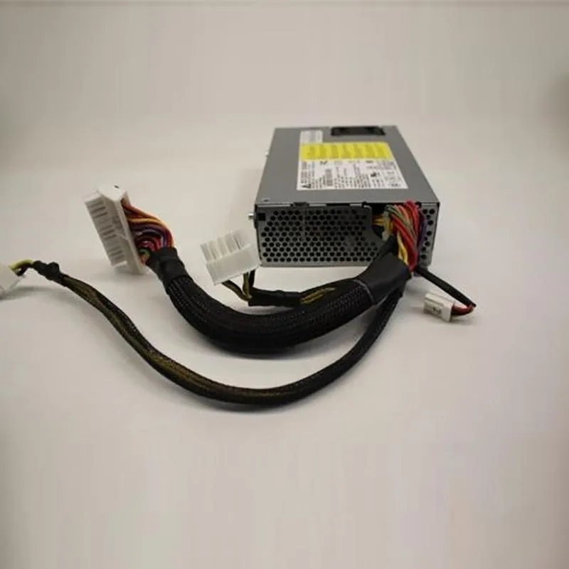 Rectangular silver metal power supply unit with ventilation grille and rear connector socket