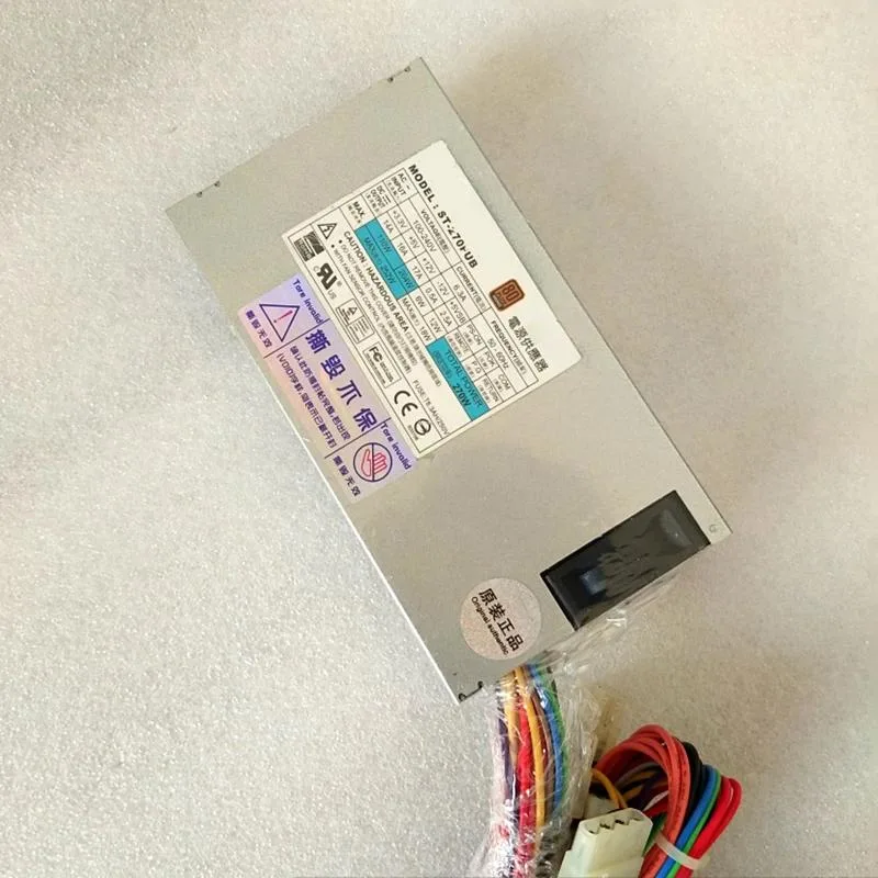 Compact silver ATX power supply unit with fan grille and cable bundle