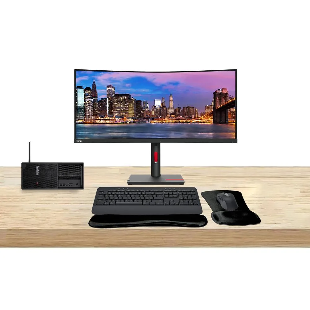 Black tower workstation beside 34-inch curved ultrawide monitor with graphite wireless keyboard and mouse set