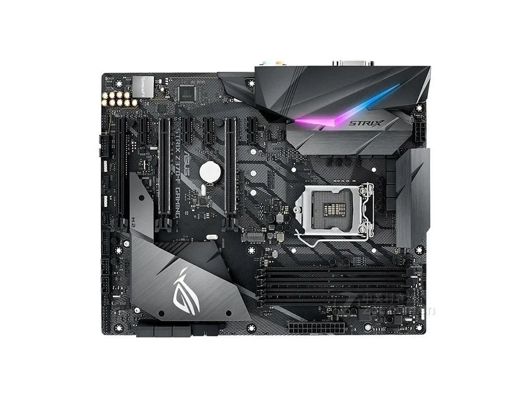 ATX motherboard, dark grey PCB with silver heatsinks, LGA 1151 socket, DDR4 slots, SATA ports, rear I/O shield included
