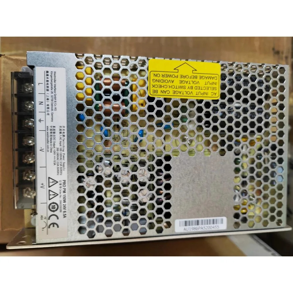 Rectangular metal ATX power supply unit with ventilation grille and label showing 150W 24V 6.5A