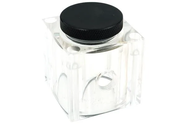 Small transparent acrylic reservoir with black fittings, 49 by 49 by 56 millimetres, shown with gasket and four mounting screws
