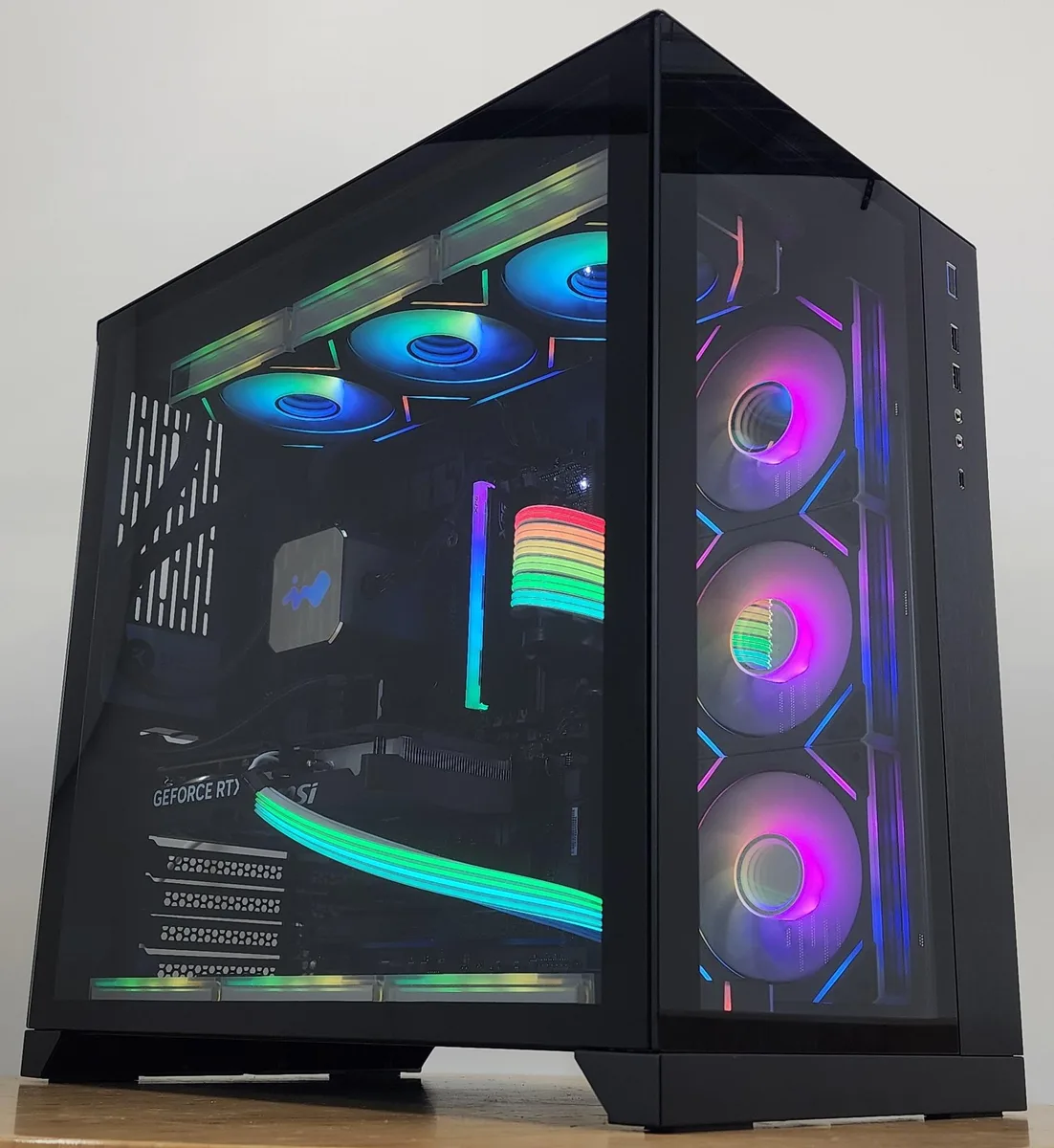 Black Lian Li O11 Dynamic ATX case with 360mm RGB AIO cooler and RTX 5060 Ti graphics card visible through tempered glass side panel