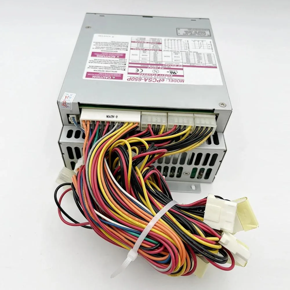 Silver ATX power supply unit, rectangular metal casing, rear fan grille, side label, power connectors visible