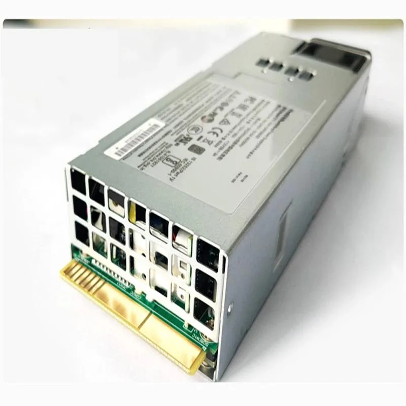 Rectangular metal power supply unit with fan grille and modular cable sockets