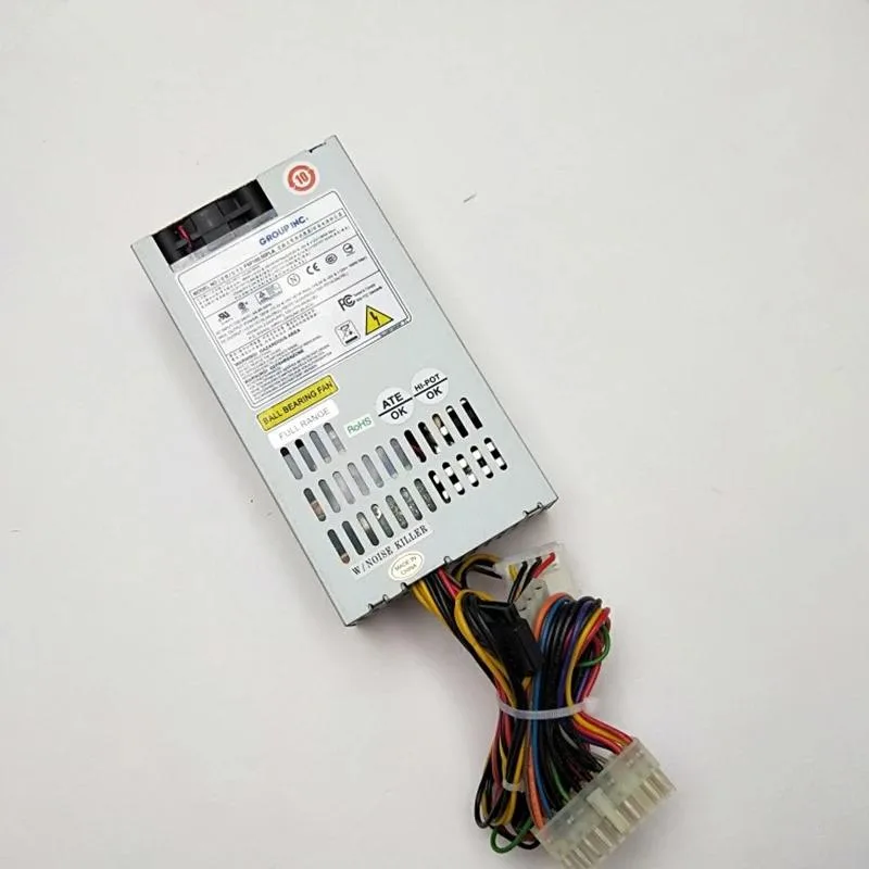 Rectangular metal ATX power supply unit with fan grille and cable bundle