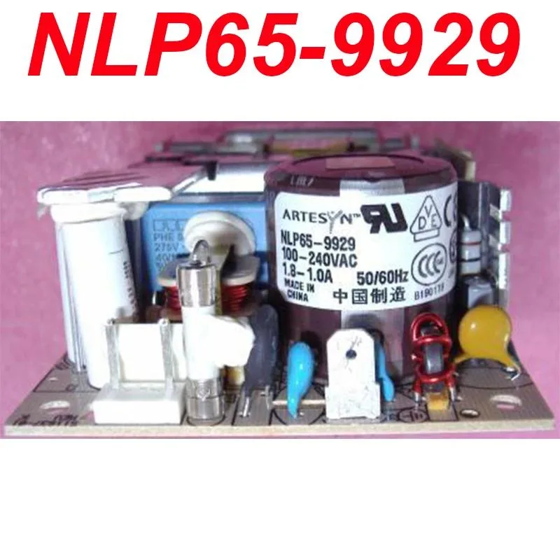Rectangular ATX power supply unit, matte black metal casing, cooling fan visible on one side, cable bundle emerging from rear