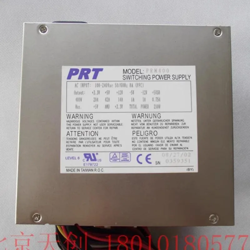Rectangular metal ATX power supply unit with ventilation grille and cables