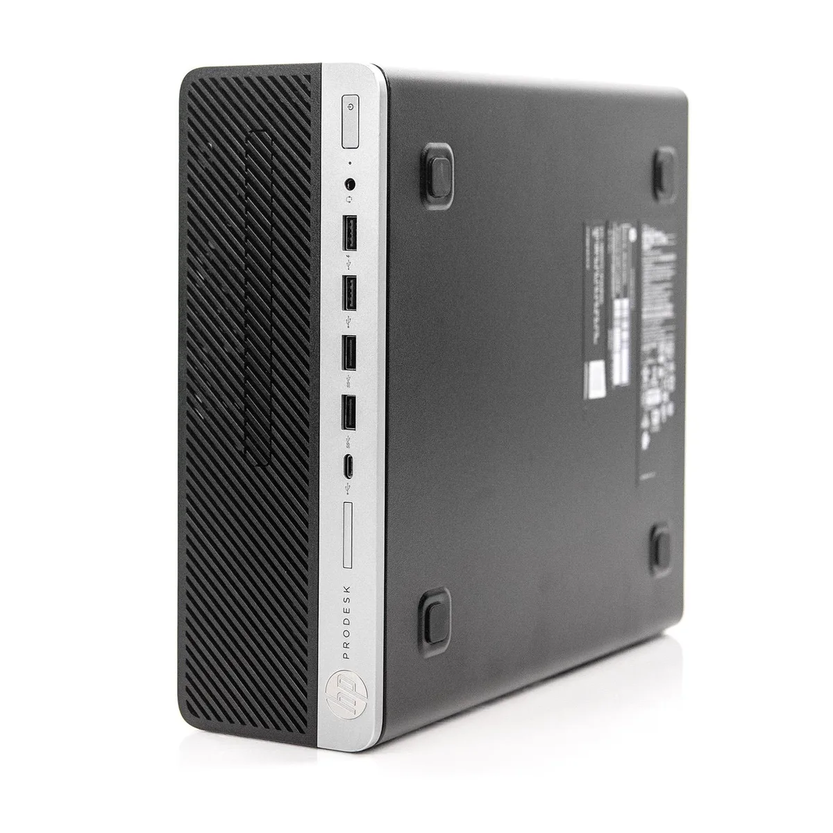 Compact silver small-form-factor desktop tower, front panel with four USB ports and no optical drive