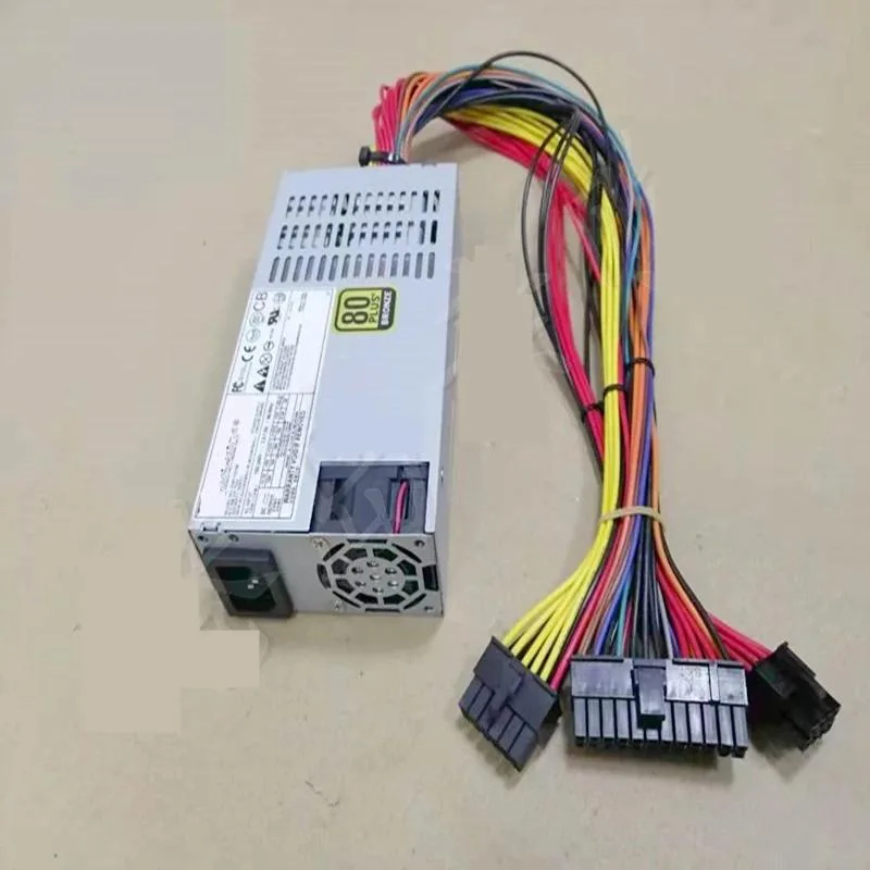 Compact silver ATX power supply unit with fan grille and cable bundle