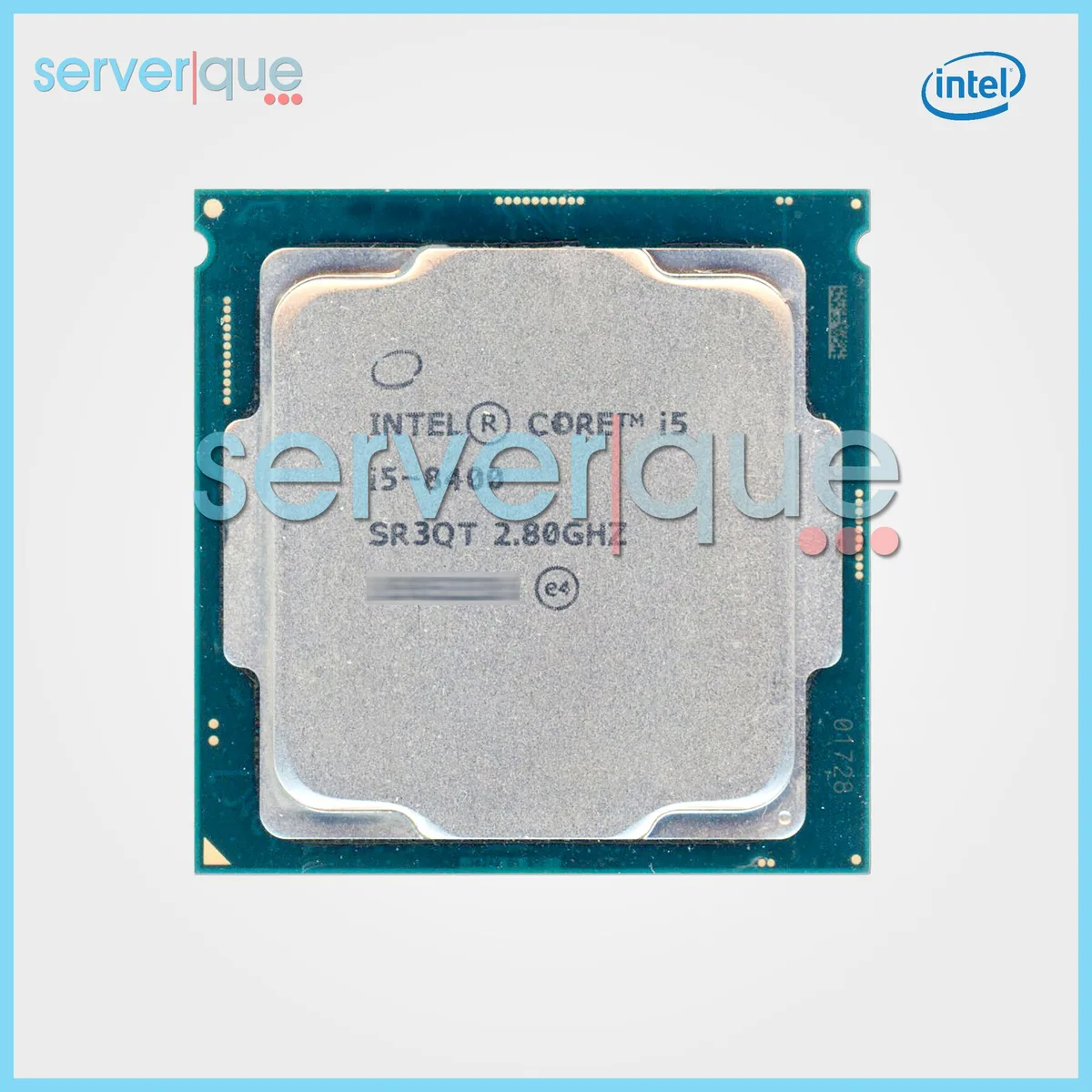 A silver rectangular CPU with gold contacts on the underside and a green substrate visible around the edges