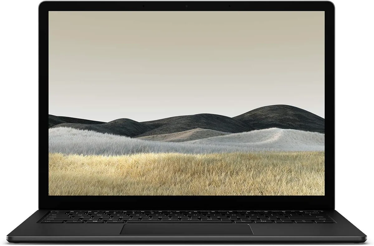 Matte black 13.5 inch laptop with touchscreen display closed on flat surface