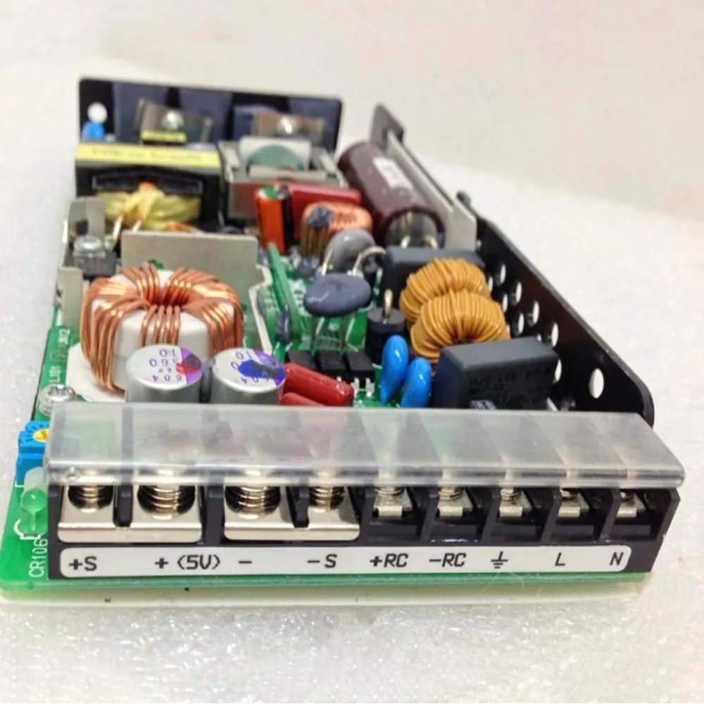 Silver rectangular ATX power supply unit with label showing 5V 20A rating