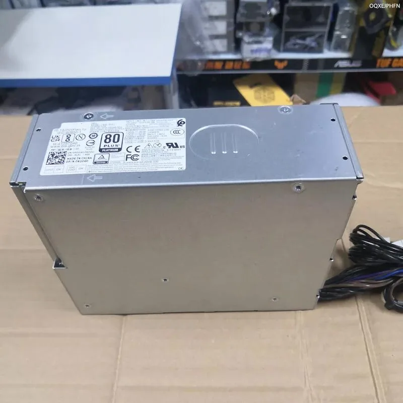 Rectangular black ATX power supply unit with side label showing model numbers