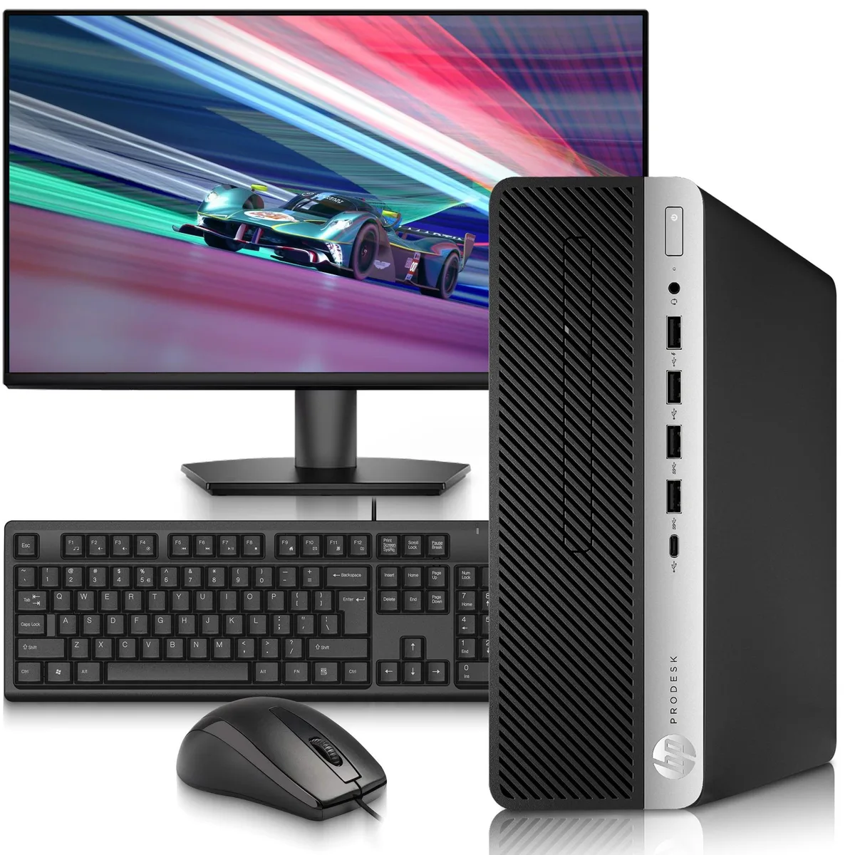 Small black desktop tower beside a 24 inch monitor with keyboard and mouse
