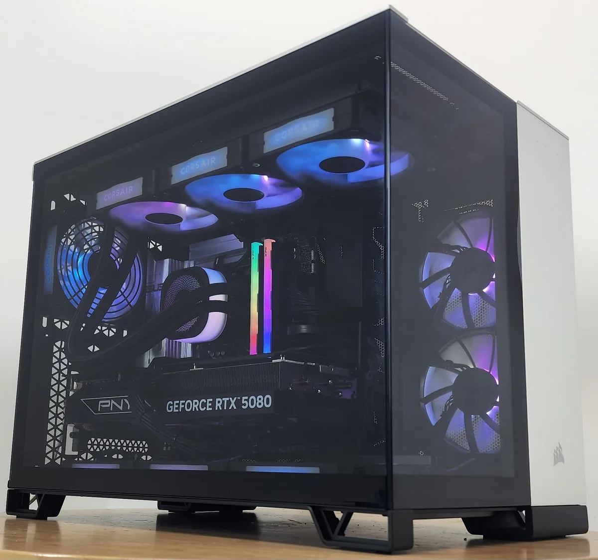 Black and silver ATX tower with RGB liquid cooler and RTX 5080 graphics card visible inside