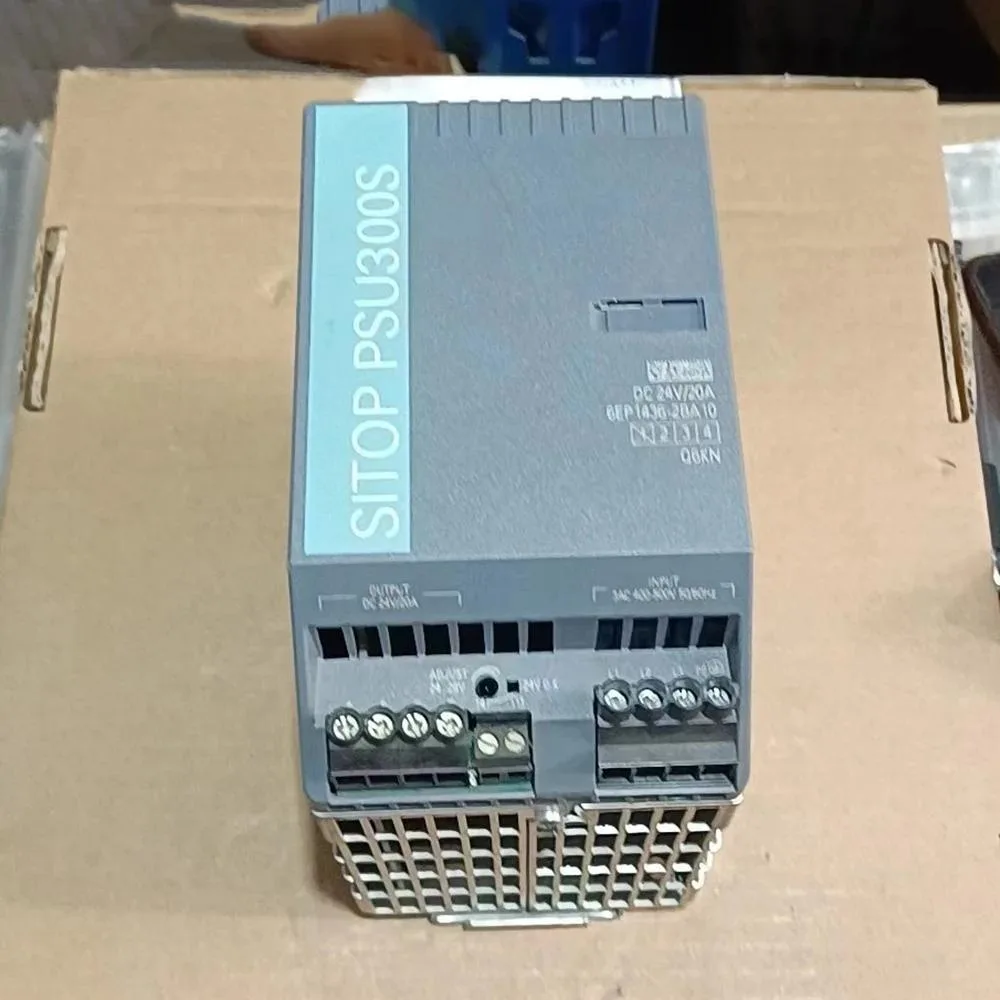 Rectangular metal power supply unit with front terminals and label