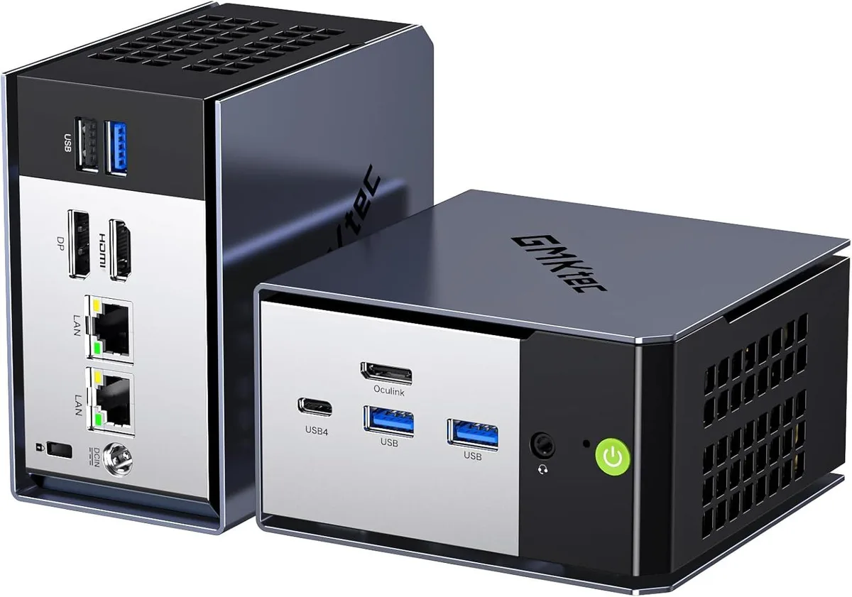 Compact gray mini PC with rounded edges and front ports