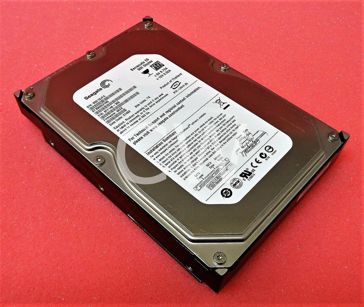 Silver rectangular 3.5 inch bare SATA hard drive with green circuit board visible