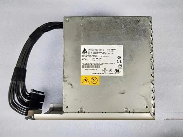 Rectangular silver ATX power supply unit with ventilation grille and label showing 980W
