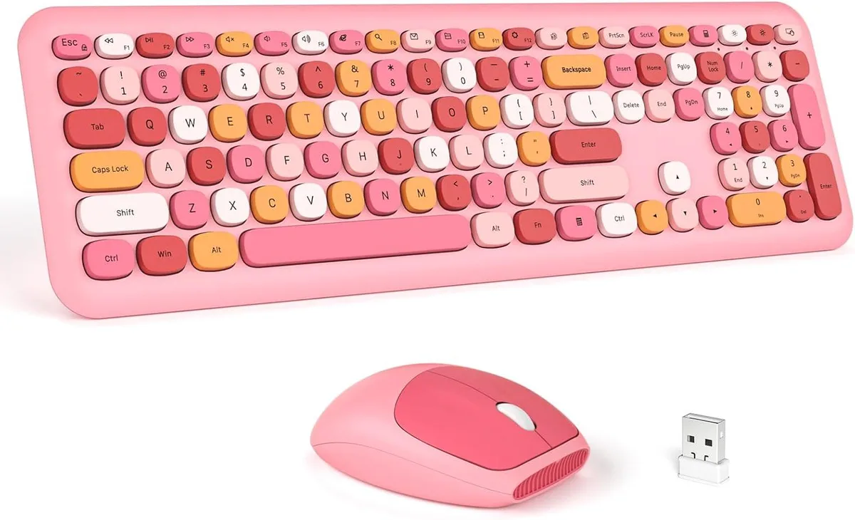 Pink full-size wireless keyboard with wrist rest and matching mouse, USB nano receiver stored in mouse