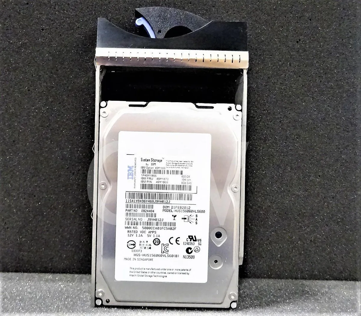 A silver 3.5 inch SAS hard drive mounted in a black server caddy tray